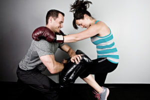 Kickboxing Instructor man and woman sparring